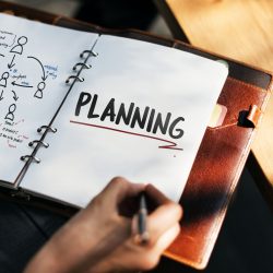 Woman writing and planning business strategy
